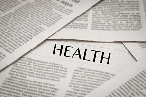 Picture of scattered papers on top of another. Headline on paper says:
HEALTH