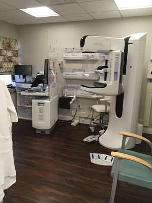 Picture of Molecular Breast Imaging Room. There is Mammography Equipment, screen monitor, and a chair